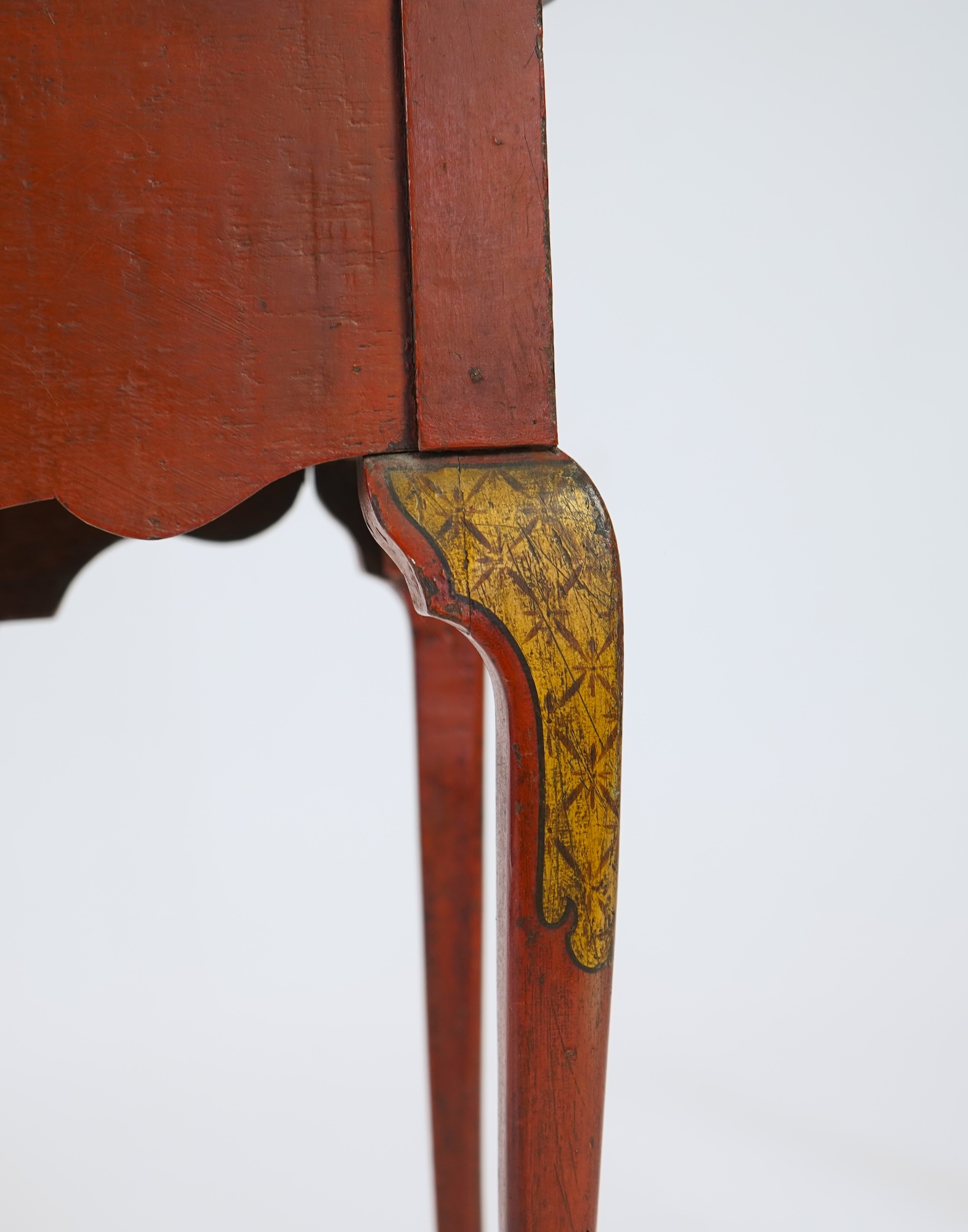 An early 18th century scarlet japanned lowboy